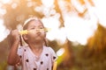 Cute asian child girl having fun to blow soap bubbles in outdoor Royalty Free Stock Photo