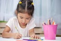 Cute asian child girl having fun to draw and paint Royalty Free Stock Photo