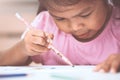 Cute asian child girl having fun to draw and paint Royalty Free Stock Photo