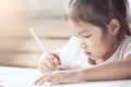 Cute asian child girl having fun to draw and paint with crayon Royalty Free Stock Photo