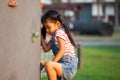 Cute asian child girl play and climbing on the rock wall Royalty Free Stock Photo