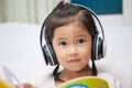 Cute asian child girl in headphones listening the music Royalty Free Stock Photo