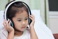 Cute asian child girl in headphones listening the music Royalty Free Stock Photo