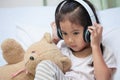 Cute asian child girl in headphones listening the music Royalty Free Stock Photo