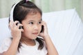Cute asian child girl in headphones listening the music Royalty Free Stock Photo