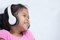 Cute asian child girl in headphones listening the music Royalty Free Stock Photo