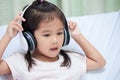 Cute asian child girl in headphones listening the music Royalty Free Stock Photo