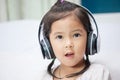 Cute asian child girl in headphones listening the music Royalty Free Stock Photo