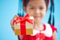 Cute asian child girl holding beautiful gift in hand Royalty Free Stock Photo