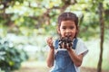 Cute asian child girl holding bunch of red grapes Royalty Free Stock Photo