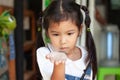 Cute asian child girl holding and playing with black caterpillar Royalty Free Stock Photo