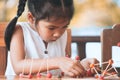 Cute asian child girl playing and creating with play dough Royalty Free Stock Photo