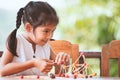 Cute asian child girl playing and creating with play dough Royalty Free Stock Photo