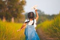 Cute asian child girl running and playing with toy airplane Royalty Free Stock Photo