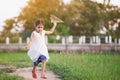Cute asian child girl running and playing toy paper airplane Royalty Free Stock Photo