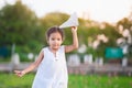 Cute asian child girl running and playing toy paper airplane Royalty Free Stock Photo