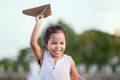 Cute asian child girl running and playing toy paper airplane Royalty Free Stock Photo