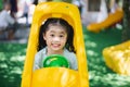 Cute asian child girl smile play toy car on school or kindergarten yard or playground. Healthy summer activity for children. Child Royalty Free Stock Photo