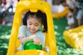 Cute asian child girl smile play toy car on school or kindergarten yard or playground. Healthy summer activity for children. Child Royalty Free Stock Photo