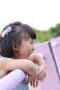 Cute Asian child girl is smiling happily in the park. Royalty Free Stock Photo