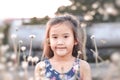 Cute Asian child girl is smiling happily in the park. Royalty Free Stock Photo