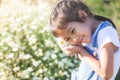 Cute asian child girl smiling and holding small flower in hand