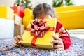 Asian child girl surprise with gift and holding beautiful gift box in hand on Christmas celebration Royalty Free Stock Photo