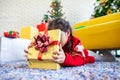 Asian child girl surprise with gift and holding beautiful gift box in hand on Christmas celebration Royalty Free Stock Photo