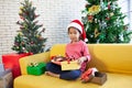 Asian child girl surprise with gift and holding beautiful gift in hand on Christmas celebration Royalty Free Stock Photo