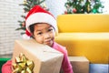 Asian child girl surprise with gift and holding beautiful gift in hand on Christmas celebration Royalty Free Stock Photo