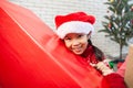 Asian child girl surprise with gift and holding beautiful gift in hand on Christmas celebration Royalty Free Stock Photo