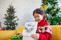 Asian child girl surprise with gift and holding beautiful gift in hand on Christmas celebration Royalty Free Stock Photo