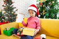 Asian child girl surprise with gift and holding beautiful gift in hand on Christmas celebration Royalty Free Stock Photo