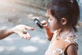 Asian child girl using magnifying glass watching beetle larvae