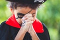 Asian child girl wearing halloween costumes and makeup making hands folded in prayer on Halloween celebration Royalty Free Stock Photo