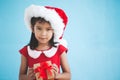 Cute asian child girl wearing santa hat and holding gift box Royalty Free Stock Photo