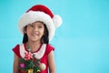 Asian child girl wearing santa hat and holding Christmas tree Royalty Free Stock Photo