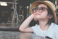 Cute Asian child girl wearing sunglasses and a hat Royalty Free Stock Photo