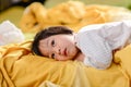 Cute Asian child lying on bed. Royalty Free Stock Photo