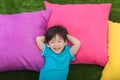 Cute asian child lying with colorful pilows Royalty Free Stock Photo