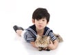 Cute asian child lying with tabby cat Royalty Free Stock Photo