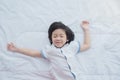 Cute asian child lying on white bed Royalty Free Stock Photo