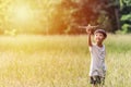 Cute Asian child playing airplane in the park outdoors Happy Asian boy holding a plane runs in a meadow with sunset Royalty Free Stock Photo