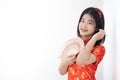 Cute Asian Chinese lady in Qipao traditional dress smiling with white space for text