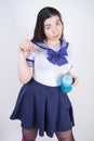 Cute asian cosplay woman with chubby body stands with cup