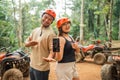 cute asian couple with savety equipment showing the blank phone Royalty Free Stock Photo