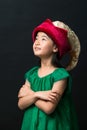 Cute asian girl child dressed in fairy hat and green dress on a black background Royalty Free Stock Photo