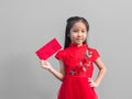 Cute Asian girl in chinese cheongsam and Tradition Chinese dress with red envelope , Chinese new year concept Royalty Free Stock Photo