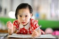 Cute Asian girl doing her homework. Royalty Free Stock Photo