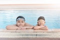 Cute asian girl and fat boy smile in swimming Royalty Free Stock Photo